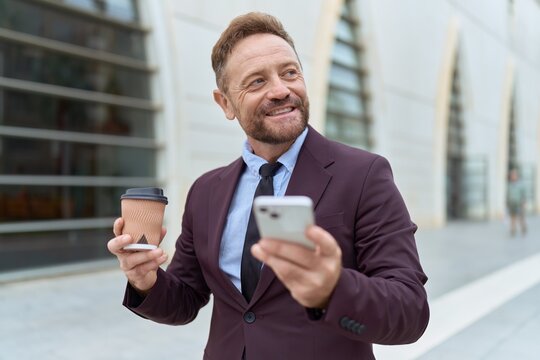 Middle age man business worker using smartphone drinking coffee at street