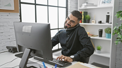 A smiling bearded man multitasking in a modern office setting, conveying professionalism and...