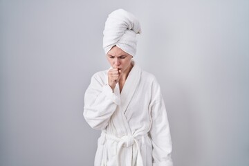 Blonde caucasian woman wearing bathrobe feeling unwell and coughing as symptom for cold or bronchitis. health care concept.