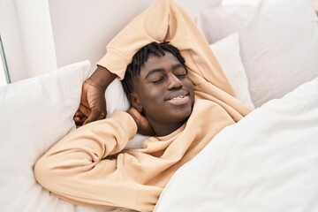 African american man lying on bed sleeping at bedroom