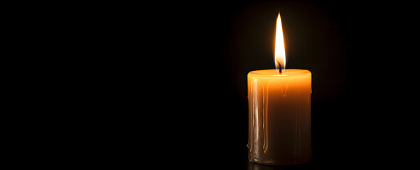 Candle on a black background, side view