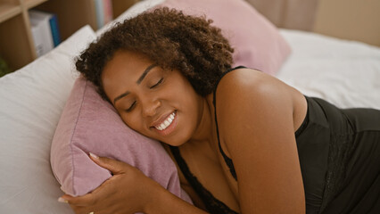 African american woman relaxing in bedroom with a smile
