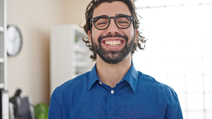Young hispanic man business worker smiling confident at the office