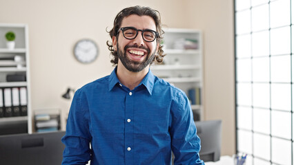 Young hispanic man business worker laughing a lot at the office - obrazy, fototapety, plakaty