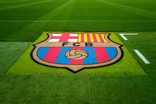 Barcelona, Spain - April 11 2023 :  Bright and vibrant FC Barcelona logo with great perspective, leading lines and green grass. Pitchside logo on astro turf. Background with copy space and texture