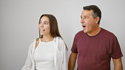 Fototapeta premium Father-daughter duo amazed, cute hispanic family looking to side with surprise, smiling confidently on white isolated background