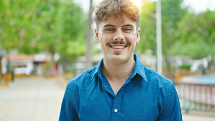 Young hispanic man smiling confident standing at park