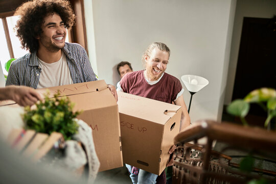 Diverse group of young people moving into a dorm together