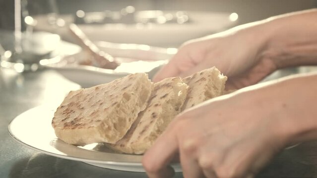 Turkish Traditional Pancake. Also Known As 'Bazlama' in Turkish. Close Up Shot. Preparing for Breakfast. Unrecognizable Person Buttering the Bread on Morning. 
