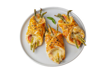 Baked green asparagus with ham and cheese in puff pastry sprinkled with sesame seeds and green...