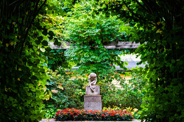 Old statue of a woman catching water in a beautiful park in germany