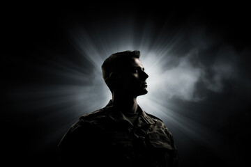 Silhouette of a male soldier on a dark background with bright rays. Generated by artificial intelligence