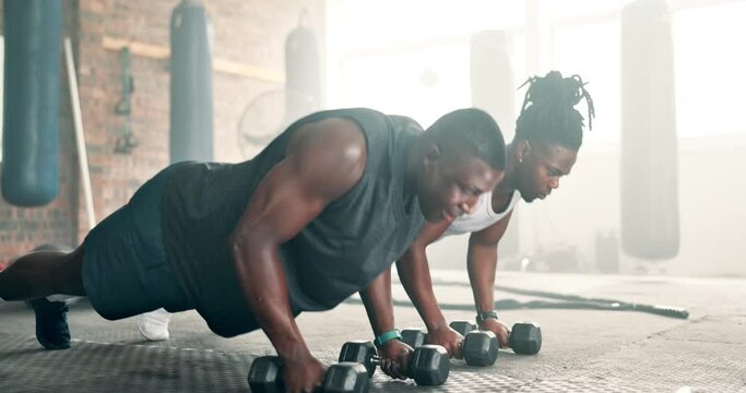 Push up, strong or men with dumbbells in gym training, exercise or workout for fitness development. Black people, healthy athletes or African bodybuilders with weights for cardio or biceps muscle