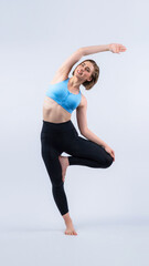 Full body length gaiety shot athletic and sporty woman doing healthy and meditative yoga exercise...