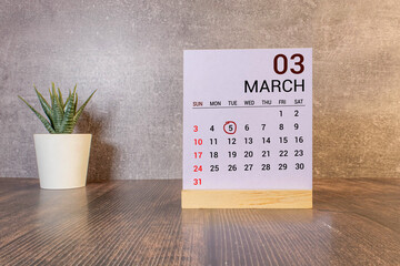 Vintage photo, March 5th. Date of 5 March on wooden cube calendar, copy space for text on board