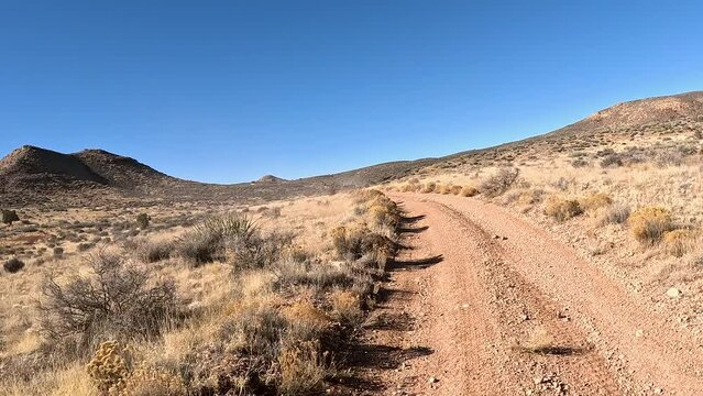 Off road recreation Utah desert valley trail follow. Off road trail riding in 4x4 all terrain vehicle for sport recreation. Utah and Arizona landscape. Grass lands, rocky terrain and mountain valley. 