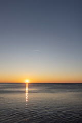 Sunrise on sea golden blue colors, Stones at sunset with blur, selective focus