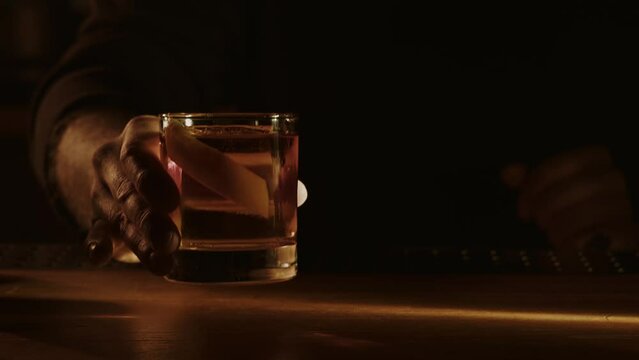 Old fashioned cocktail in hand