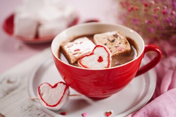 Valentines day hot chocolate or cocoa with homemade heart marshmallows on pink background