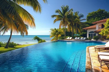 Foto op Canvas A tranquil oasis awaits at this seaside resort town, with a stunning pool surrounded by swaying palm trees and a luxurious house overlooking the crystal blue water © LifeMedia