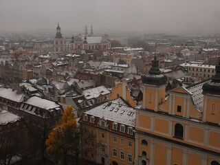 Obraz premium View of Poznan Poland on a snowy November day with the roofs of old houses and steeples of catholic churches