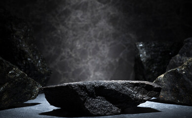 granite stones for the podium. black natural stones with texture on a dark background for a...