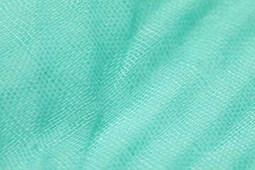 Texture of turquoise fabric as background, closeup