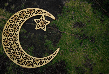 Crescent moon on green textured background,2024 Ramadan background, Eid Mubarak concept theme...