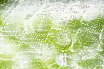 Water surface. Bluewater waves on the surface ripples blurred. Defocus blurred transparent blue colored clear calm water surface texture with splash and bubbles. Water waves with shining pattern.