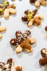 Fototapeta na wymiar Making Cutout Sugar Cookies, Chocolate-Dipped, Hazelnut-Sprinkled