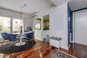 A contemporary decorated living room with white furniture and a circular dining table