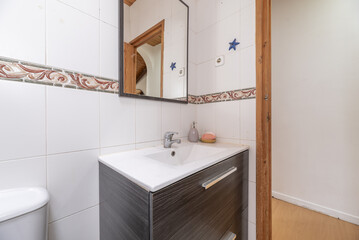 A small bathroom with white porcelain toilets on dark wood furniture