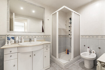 Fototapeta na wymiar Bathroom with white furniture, square shower cabin