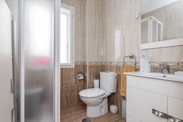 A small bathroom with white furniture