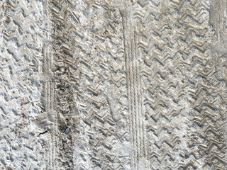 Texture of motor vehicle tire tracks on the beach. View of car tire tracks on the beach sand
