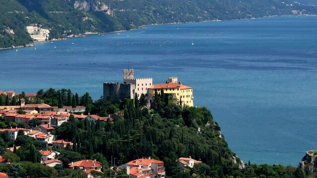 drone view of duino's castle near to the sea in trieste
