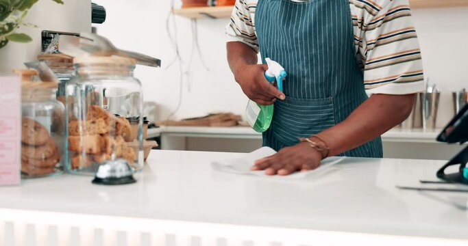 Barista, hands or cleaning table in cafe for dust, bacteria and dirt with cloth, spray or detergent. Waiter closeup, person or wipe furniture surface in coffee shop or restaurant with chemical liquid