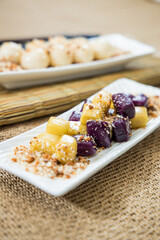 Taiwanese traditional sweet and dessert, glutinous rice dumplings and sweet potato dumplings with coconut sugar and peanuts and coconut flakes