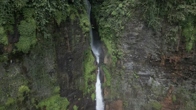 Aerial view of deep narrow cliff grotto at Kapas Biru waterfall, Java