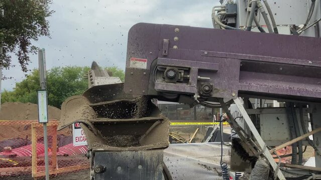 Focused Detail: Slinger Conveyor Belt in Action, Propelling Rocks for Gas Station Tank Backfilling