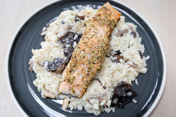 Salmon on top of risotto.