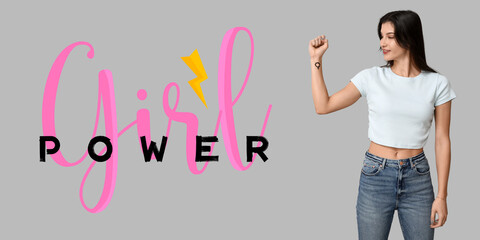 Young woman showing female gender symbol on her wrist against grey background. Girl power