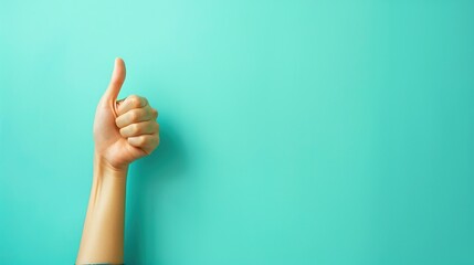 Closeup of hand showing thumbs up sign isolated on turquoise background. Copy space for ad text. - obrazy, fototapety, plakaty