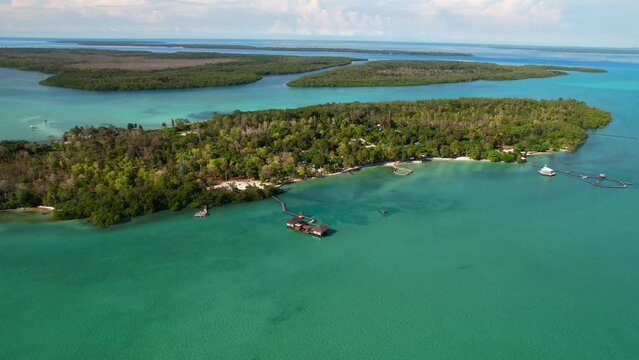 Aerial panorama of a private island surrounded by the sea with turquoise water at Leebong Island, Belitung, Indonesia