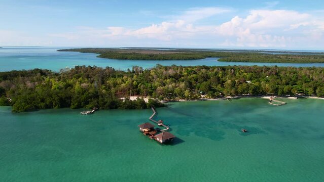 Breathtaking aerial view of a private villa resort with mangrove trees surrounded by blue ocean at Leebong Island in Belitung Indonesia