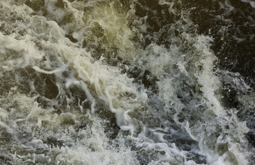Waves of water of the river and the sea meet each other during high tide and low tide. Deep blue...