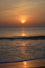 Golden Sunrise in Sri Lankan Beach, twilight glowing at Horizon, The tranquil beach, gently kissed by the first light, reflects the magical transformation of a new day.