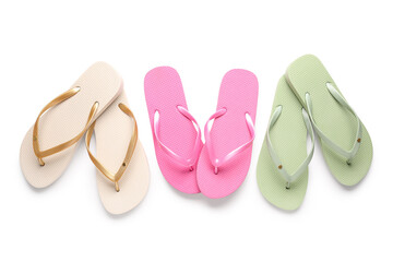 Colorful pairs of female flip flops on white background