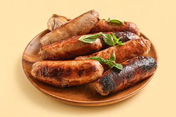 Plate of tasty grilled sausages on yellow background
