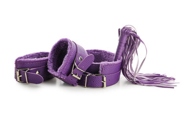 Purple collar with whip and handcuffs from sex shop on white background
